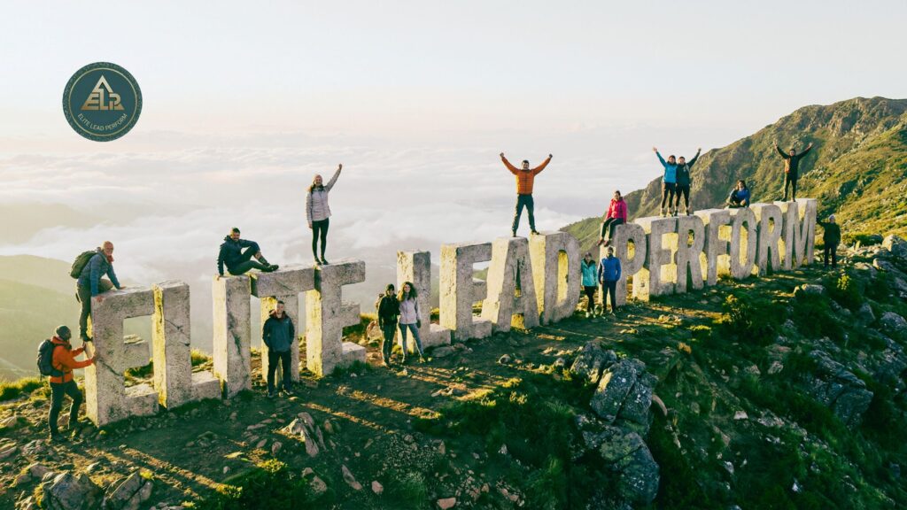 Group of people standing on a mountain ridge with the words “Elite Lead Perform,” symbolizing personal growth through clarity, structure, and conscious action.